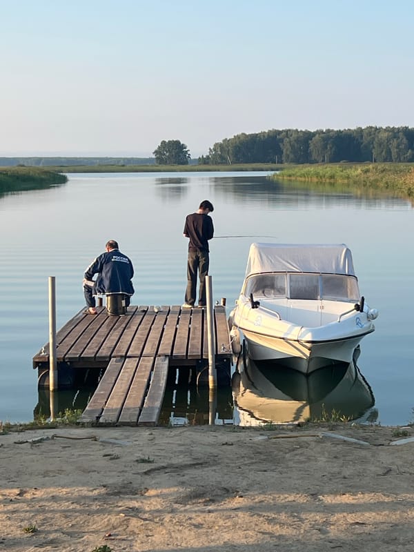 Pier and docked boat on a calm Russian lakeside evening