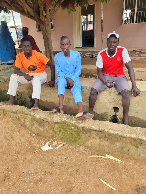 Afternoon street life outside a building in Madalla, Nigeria