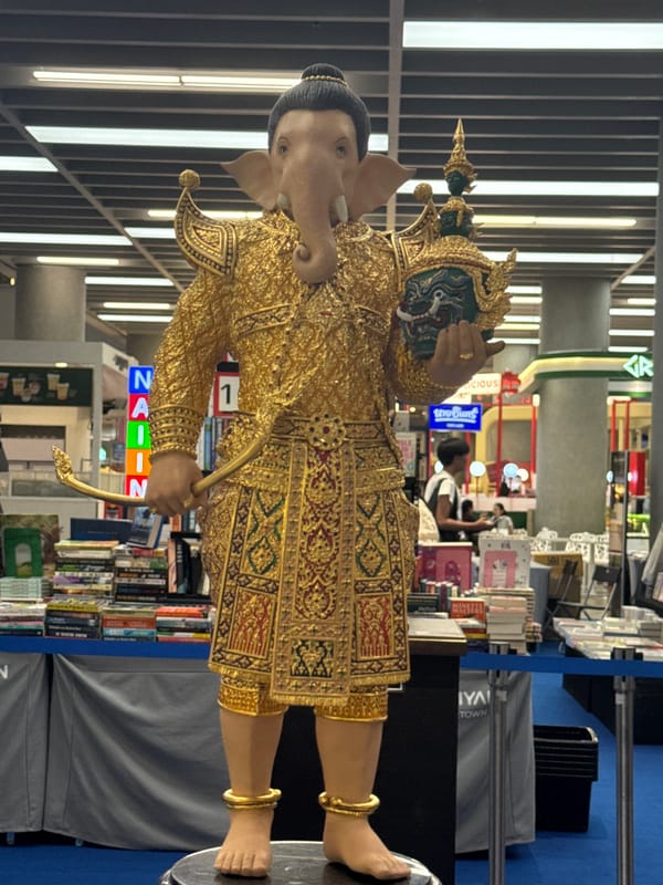 Rainy Bangkok evening: shrines, skyline, and a mall stage show