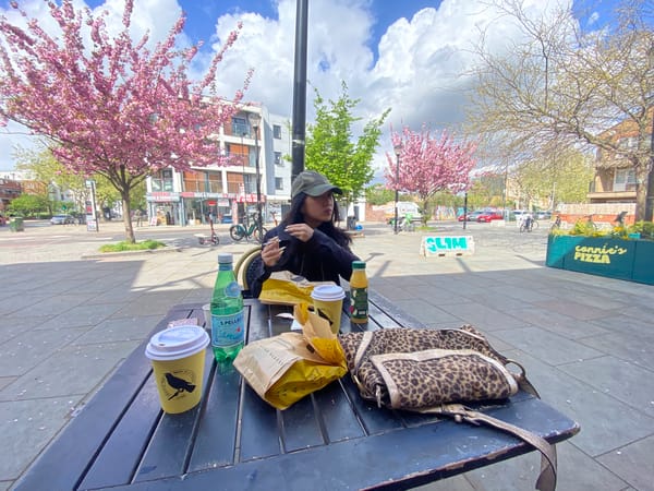 Woman enjoys Blackbird Bakery meal at London picnic table