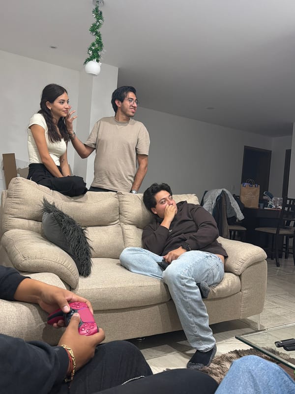Four people gather on couch in Mexican living room