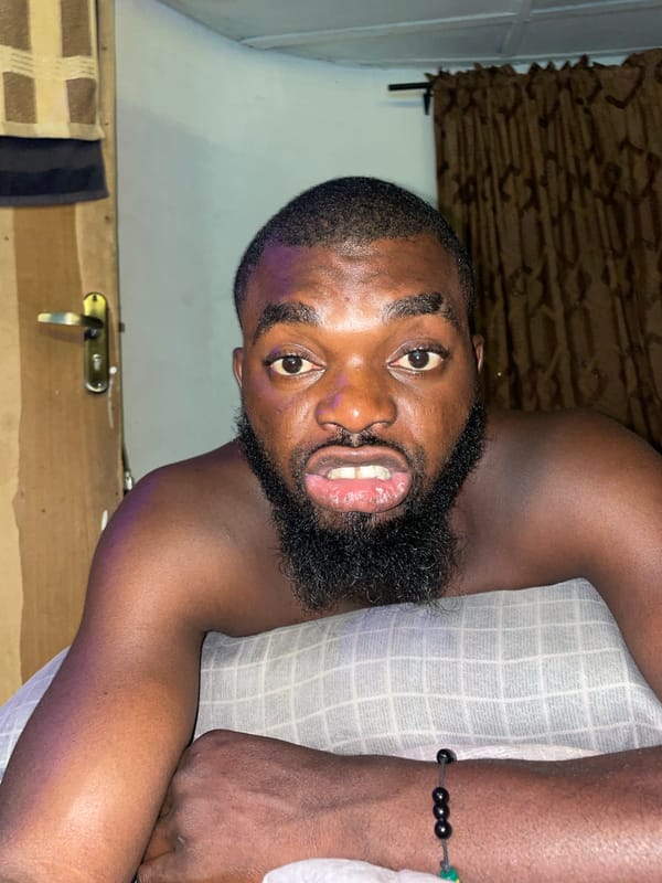 Man with remote and local shops captured in Jos Nigeria