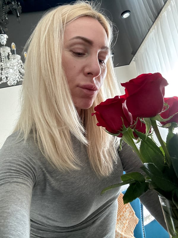 Woman photographed with red roses indoors in Russia
