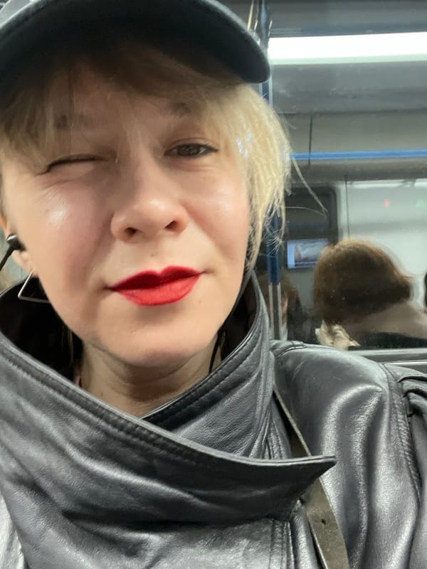 Woman in leather jacket winks in Moscow street scene