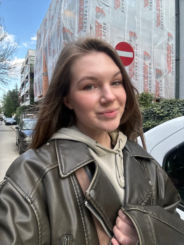 Woman takes selfie in Belgrade suburb amid urban streetscape