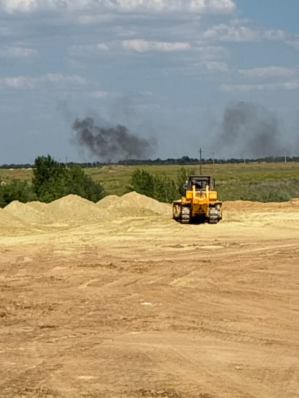 Bulldozer at work on a dusty construction site in Zhirnov