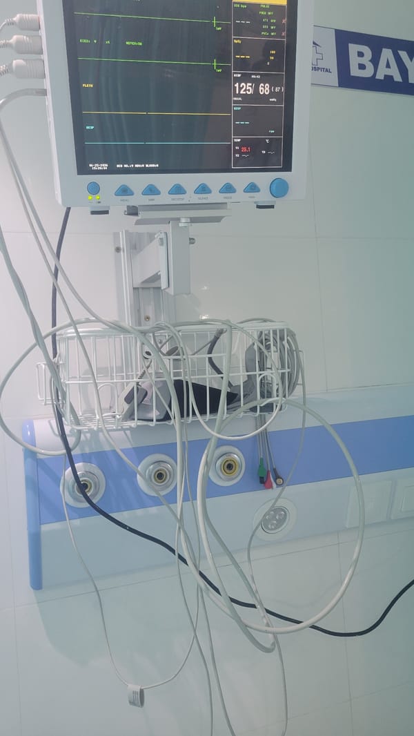 Inside a Dar es Salaam medical setting, morning of June 25