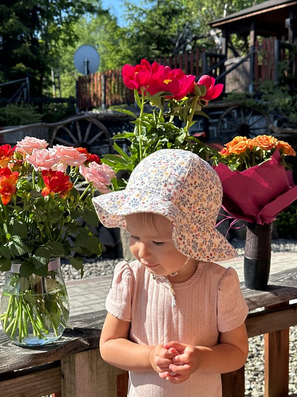 Baby photographed with peony bouquets in Wisła, Poland
