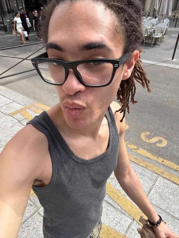 Selfie moment on a Paris sidewalk near a café