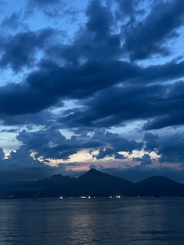 Dusk over Đà Nẵng's coastline, clouds and fading light