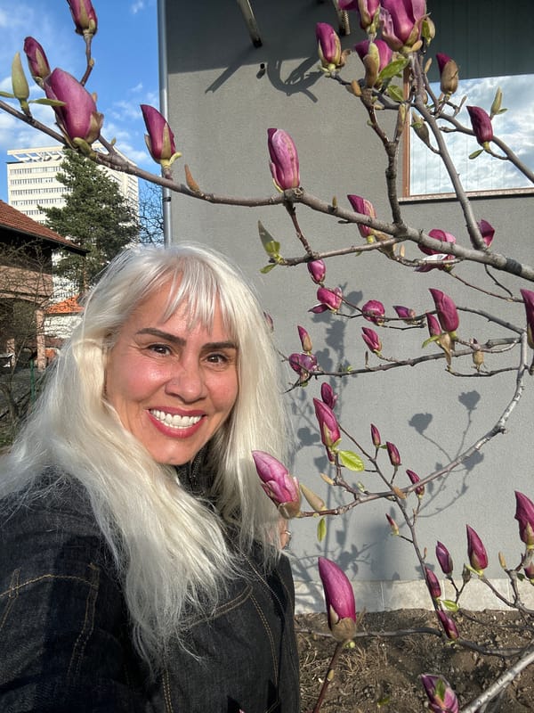 Woman poses with spring magnolia blooms in Sofia