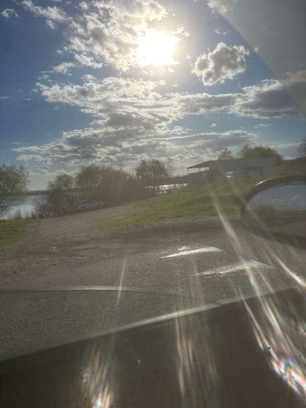 Sunny skies observed through vehicle windshield in Burgas