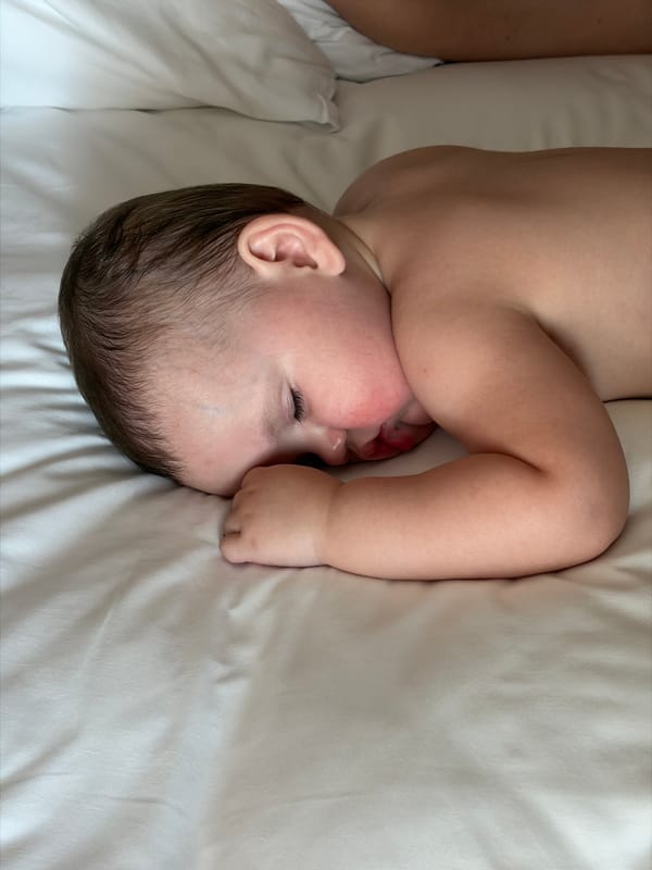 Baby observed resting on white sheet in Đà Nẵng