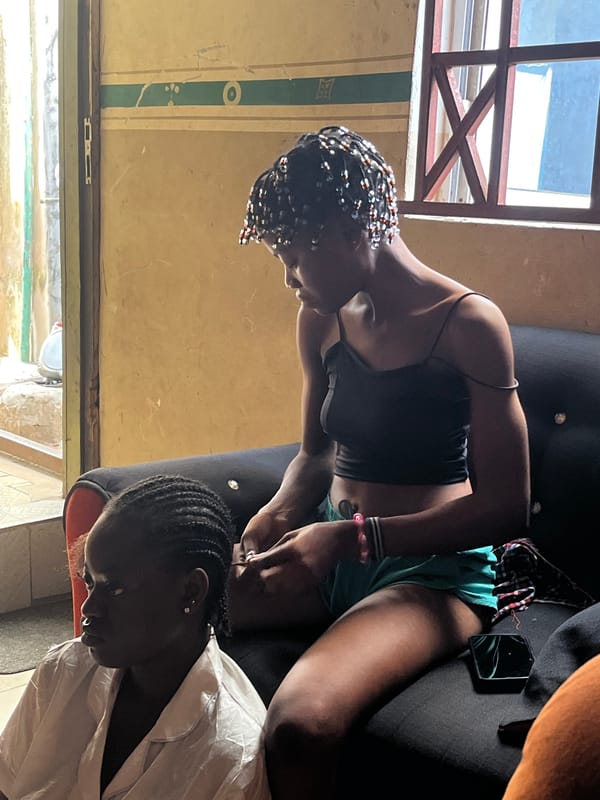 Hair braiding session documented in Badagry residential setting