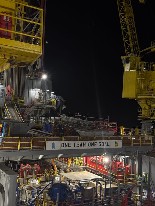 Illuminated drilling rig photographed at night in Italy