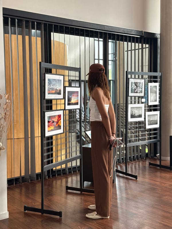 Woman visits photo display and antique typewriter in Domont