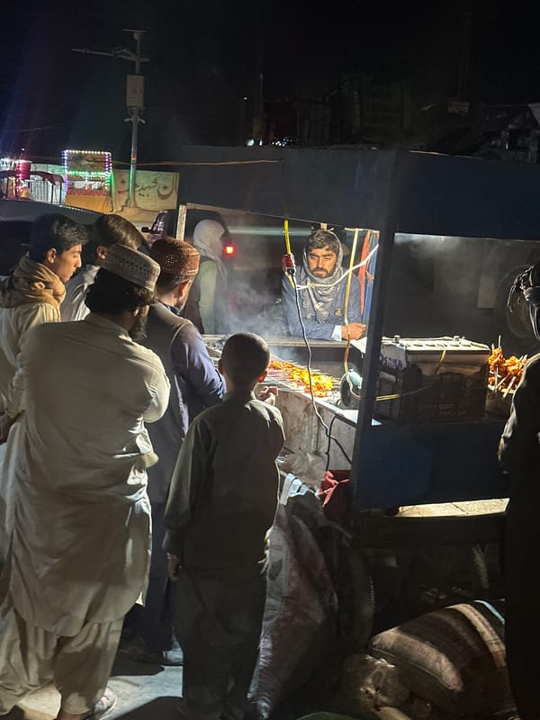 Evening market vendors serve customers in Quetta City