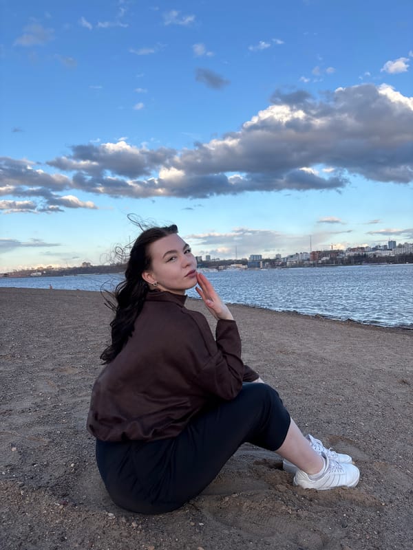 Woman poses for photograph on riverbank in Perm, Russia