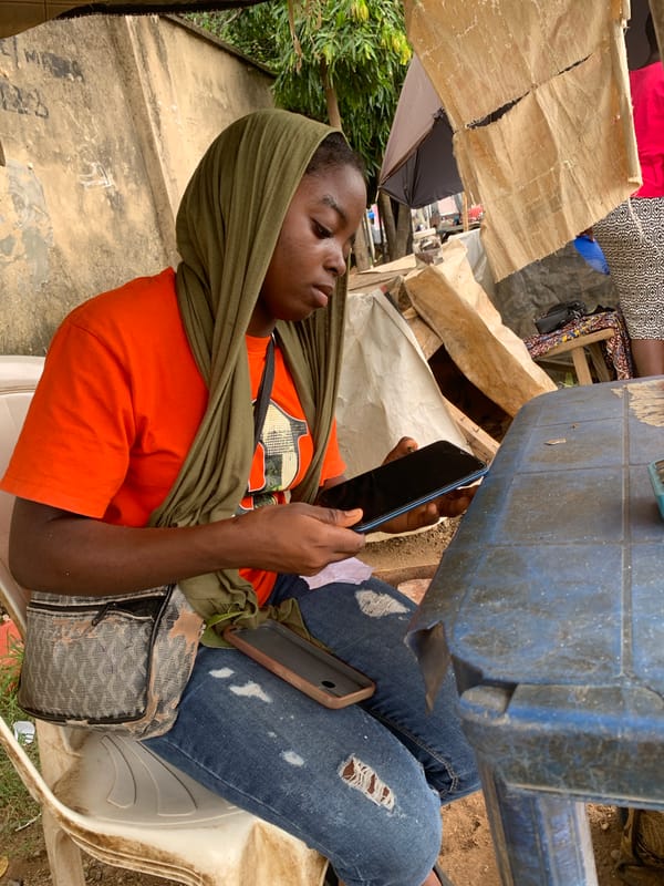 Busy Abuja roadside corner: vendors, commuters, and street life