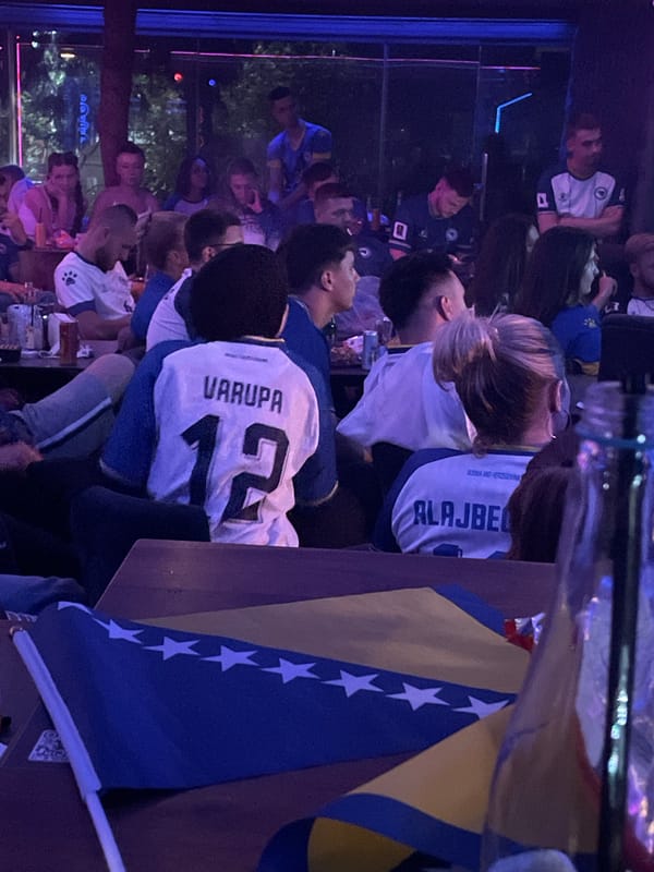 Neon-lit venue hosts what looks like a Bosnian cultural gathering