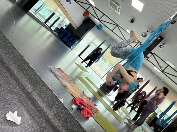Woman Takes Selfie While Suspended in Aerial Yoga Hammock
