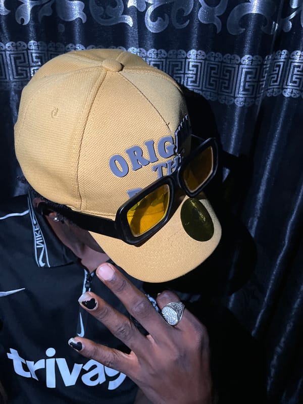 Man poses in Chelsea jersey and yellow accessories in Lokoja