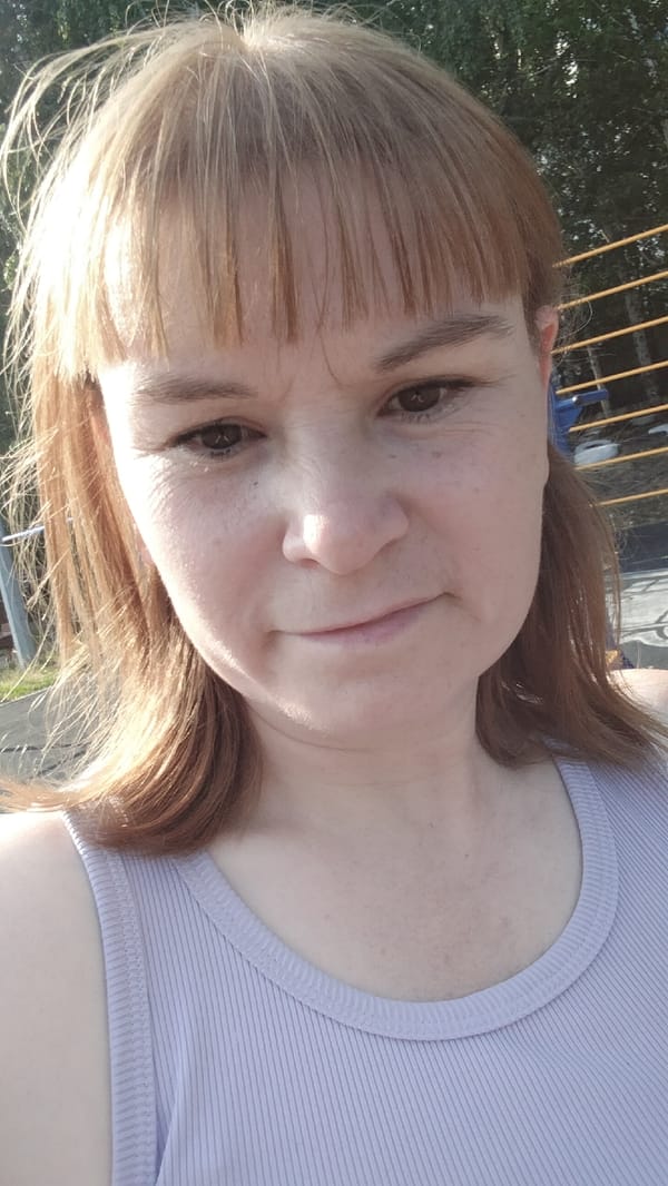Sunny day out with flowers, a parking lot, and a plush bunny