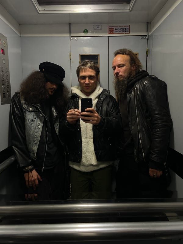 Musician plays green electric guitar in Belgrade apartment