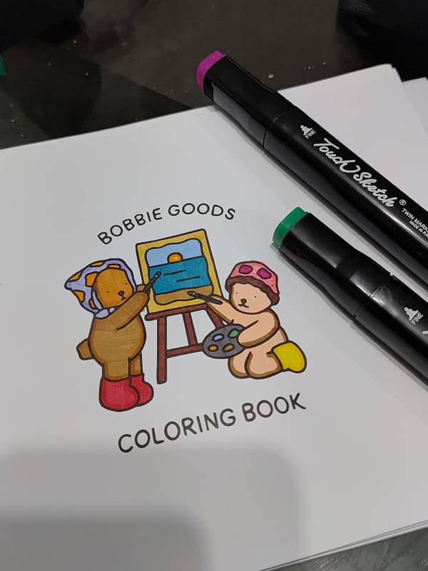 Art supplies and coloring book captured in Curitiba home
