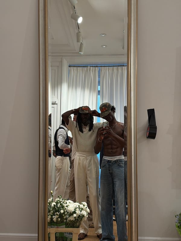 Inside a Milan fashion event, phones up and people gathered