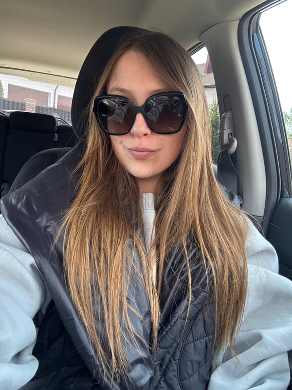 Woman in sunglasses observed in car passenger seat, Belarus