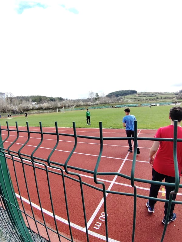 Two men walk on sports track in Panagyurishte, Bulgaria