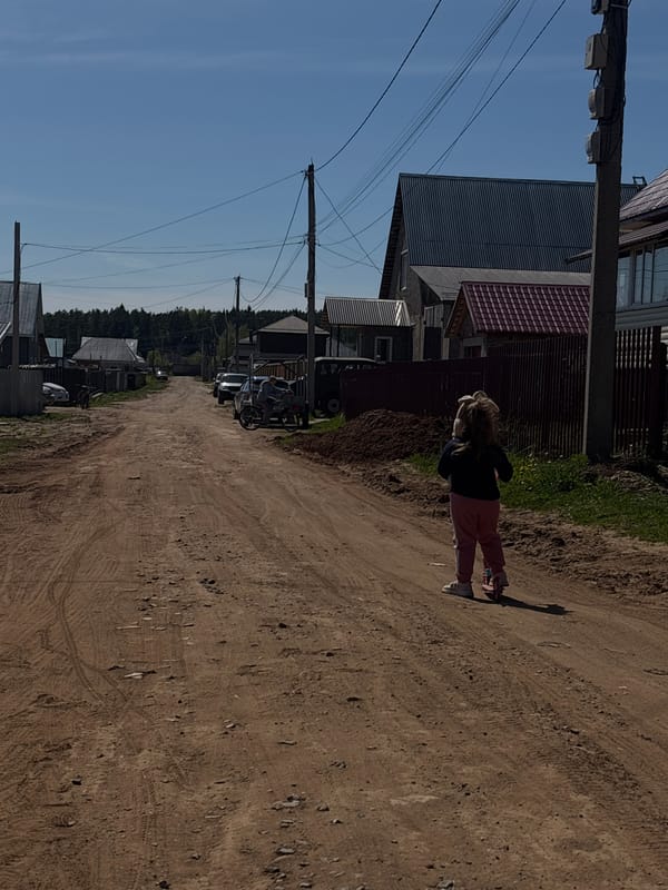 Person stands on dirt road in Prikamskii, Russia