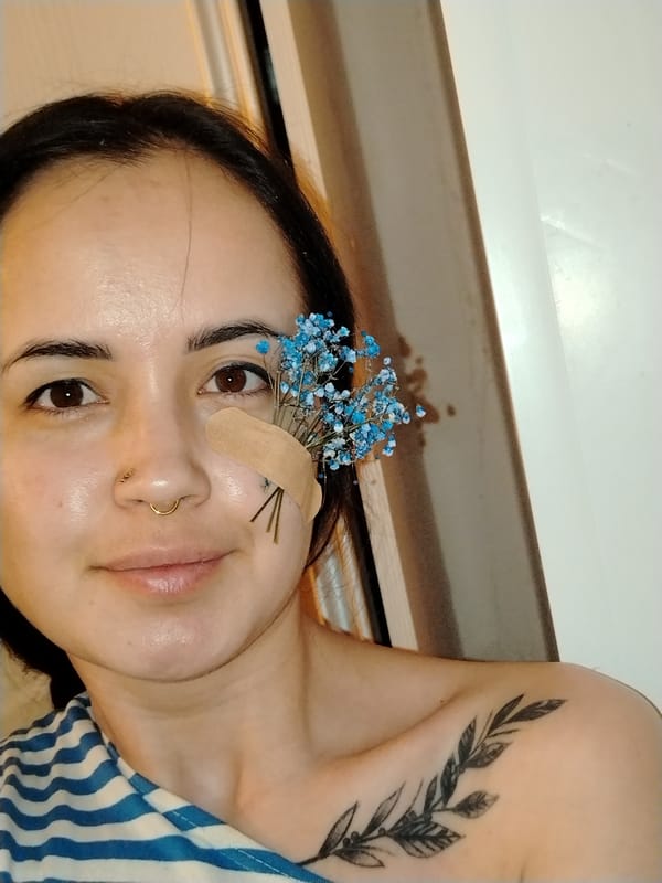 Woman applies makeup with bandaged cheek in Noviy, Russia