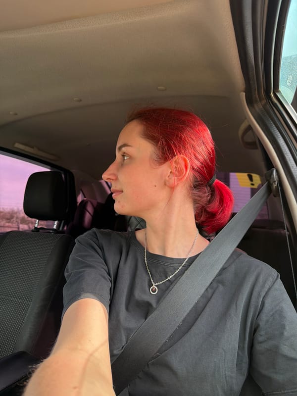 Red-haired woman observed in vehicle interior in Chaikovsky