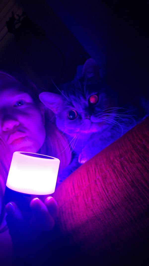 Woman and cat photographed with blue lighting in Chaikovsky