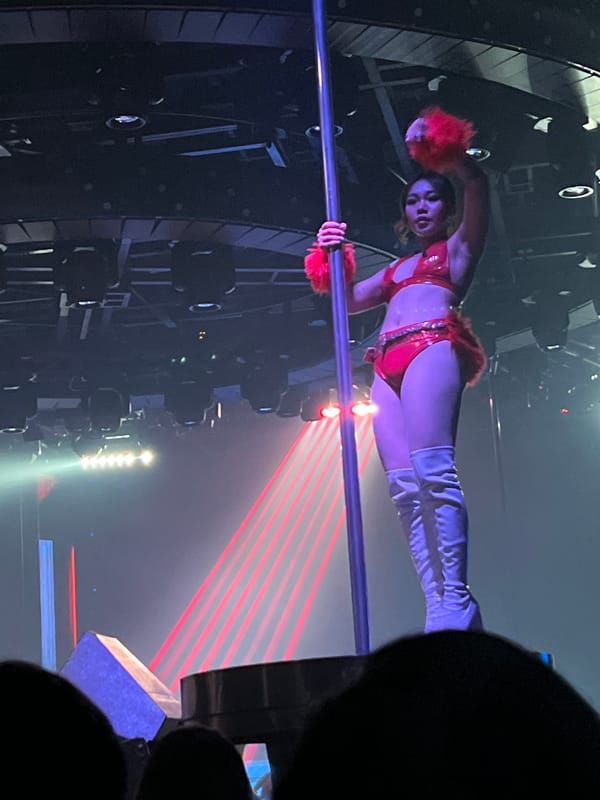 Nightclub scene with pole performance and DJ set in Đà Nẵng