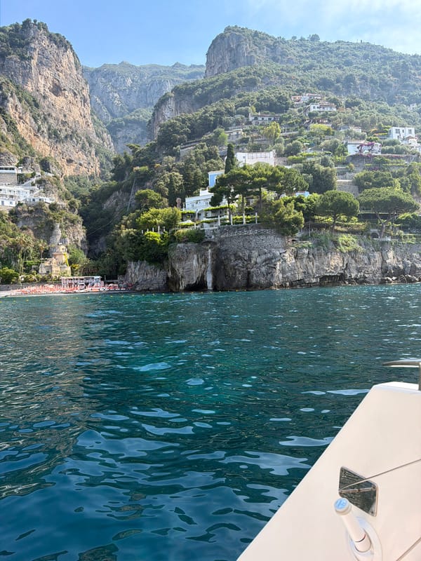 Boat passengers capture scenic Italian coastline views near Positano