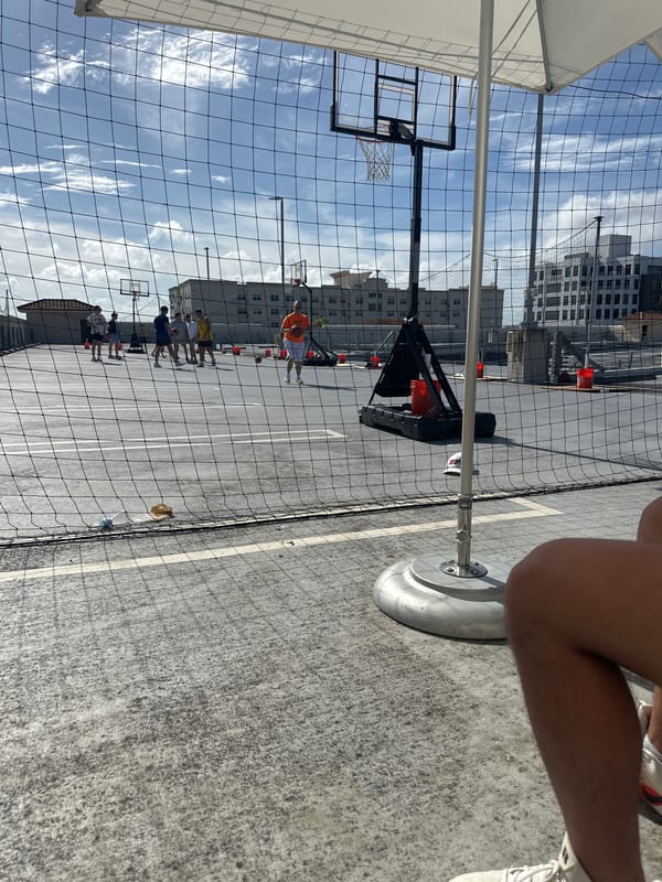 Evening basketball game observed on outdoor court in Aventura