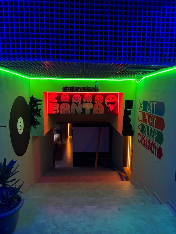 Neon-lit interior space with graffiti documented in Meknes