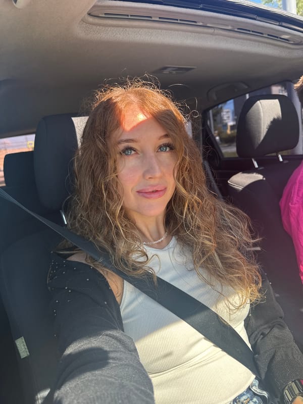 Woman photographs daisies, beetles during early morning car trip