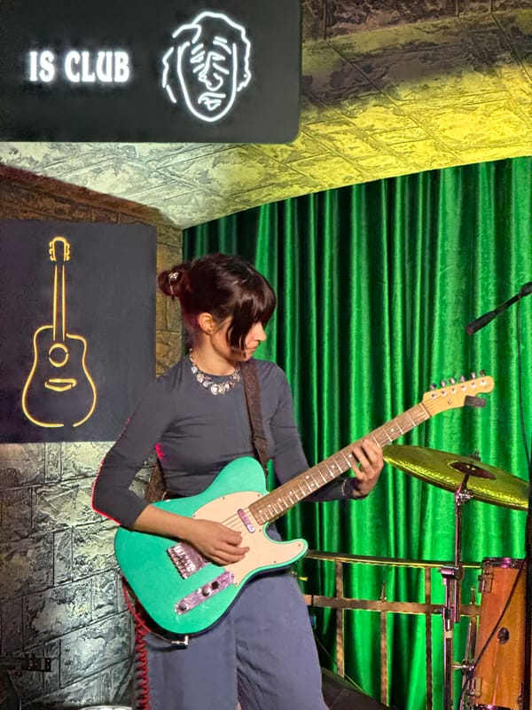 Live band performance featuring female guitarist at Moscow club