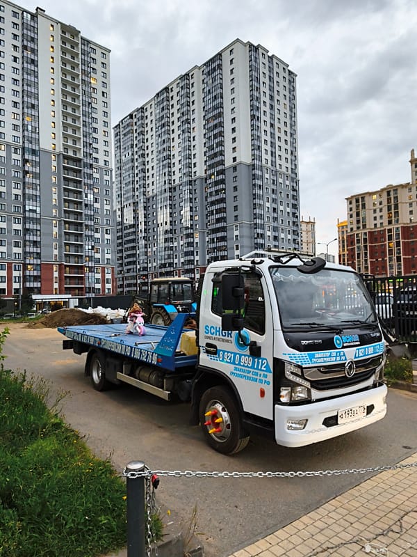 St. Petersburg tow truck parked with a doll strapped to its flatbed