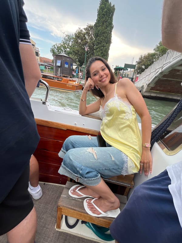 Boat tour navigates Venice canals passing historic landmarks
