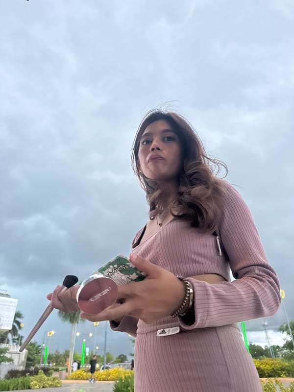 Woman applies makeup on public bench in Davao City