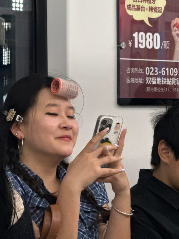 Commuter with hair roller uses phone on Shuangfu train