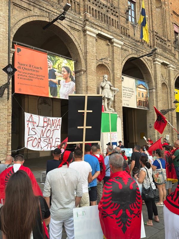 Albanian community gathers in Parma streets, flags and capes on display