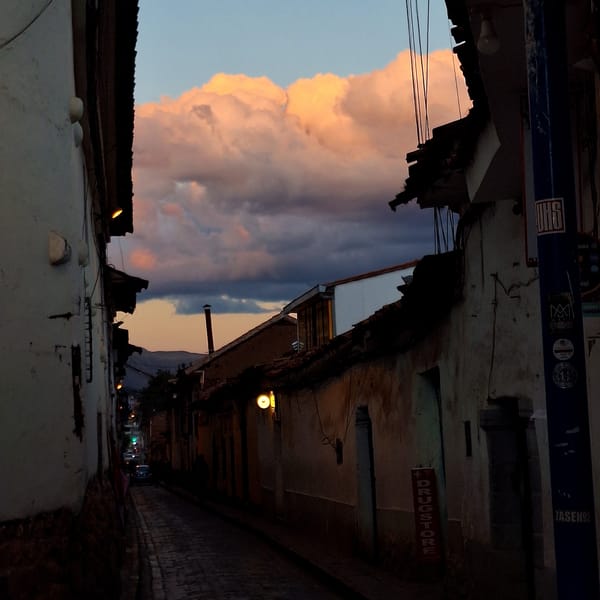 Dusk clouds photographed over historic Cusco streets