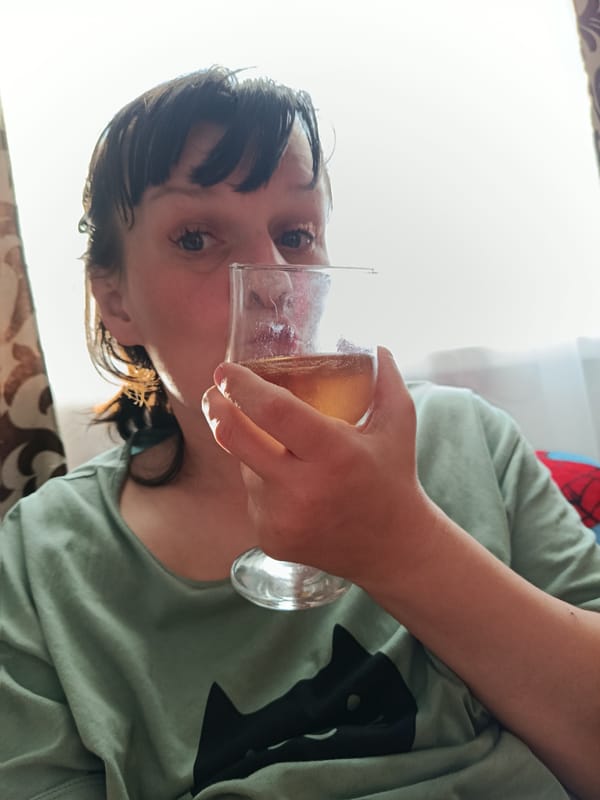 Person enjoys light beverage in green cat shirt, Foki