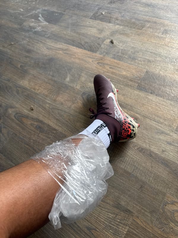 Soccer player treats leg injury with ice pack